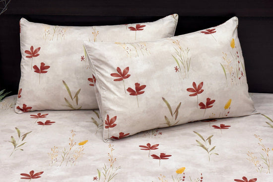 cotton white bedsheet with floral and leaf print and two pillows neatly arranged on bed 1