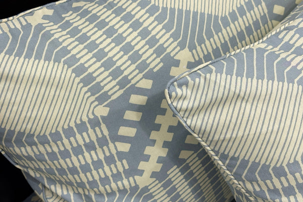 pillows featuring geometric blue and beige designs . 