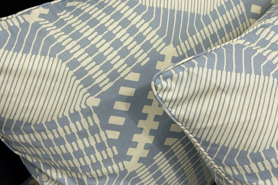 pillows featuring geometric blue and beige designs . 