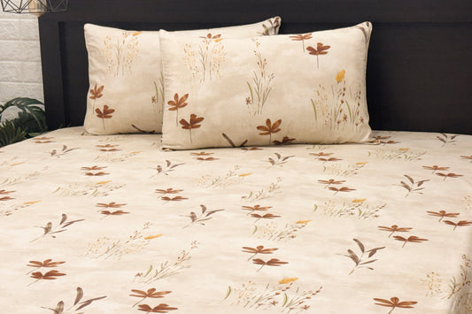 pink cotton bedsheets with floral and leaf printed and matching pillows .