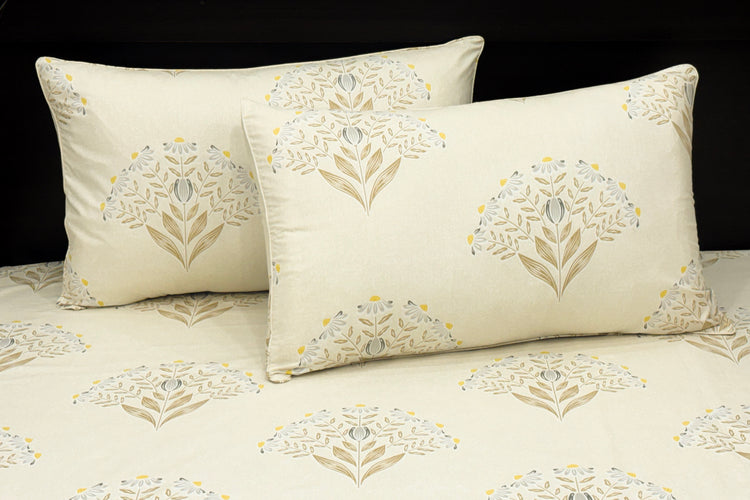 white cotton bedsheet with brown,blue floral printed and matching pillows neaty arranged on bed 1