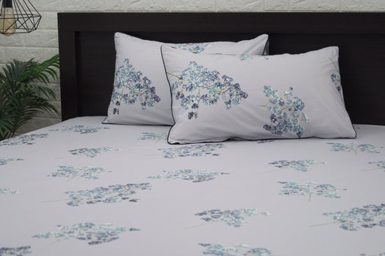 A set of two pillows with a floral print design bedsheet in shades of purple 2