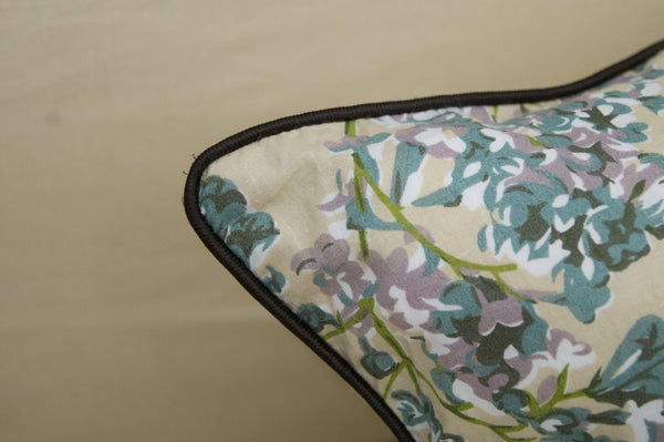  pillow with floral patterns, featuring small purple and green flowers.